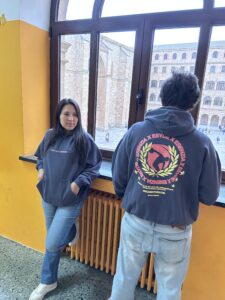 Dos alumnos de ESYDE Salamanca apoyados en la ventana con la sudadera de Esenzia